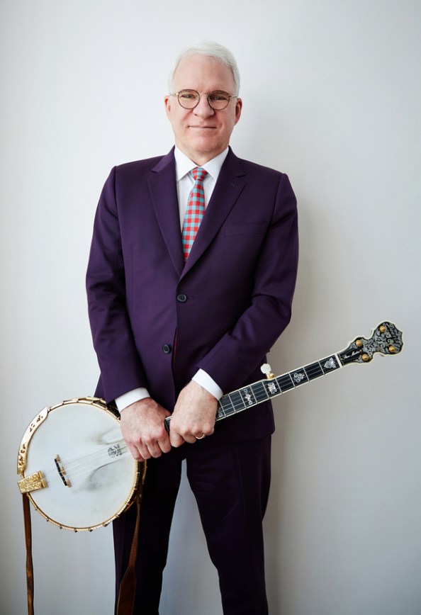 photo of Steve Martin standing, holding a banjo