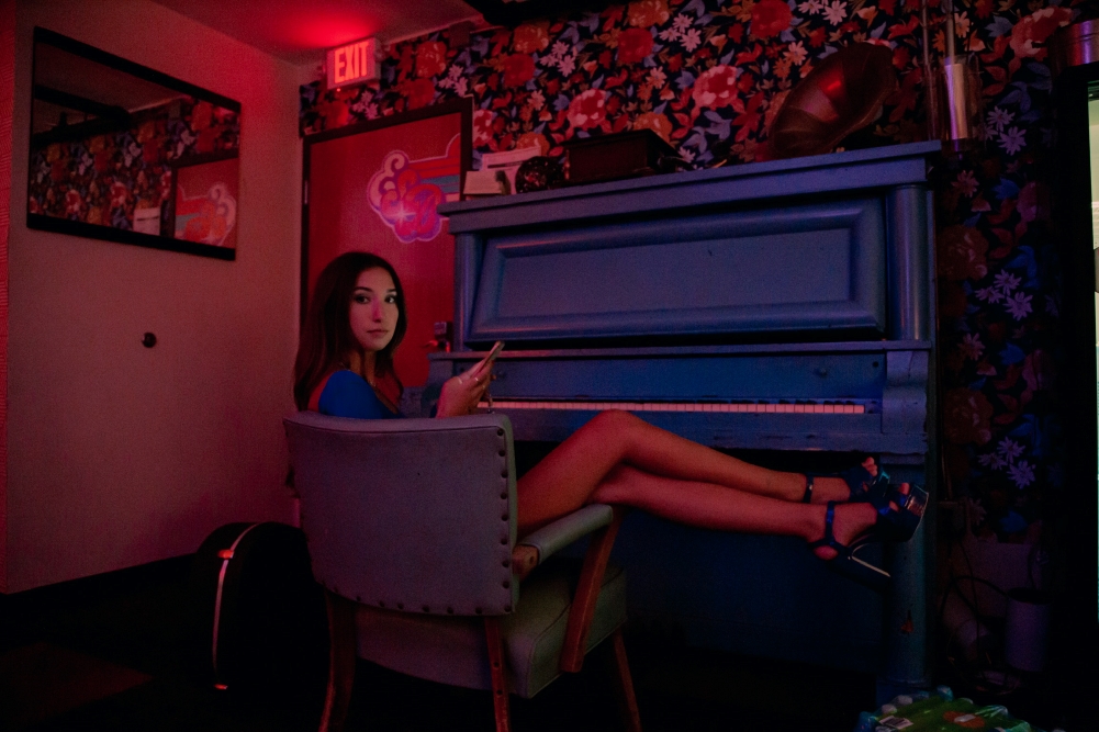 Erin Gibney seated in front of a piano